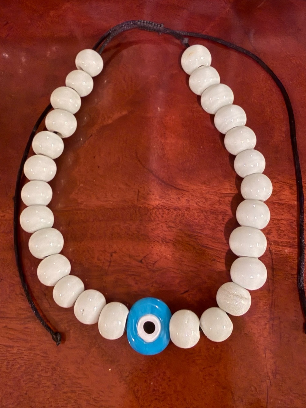 White Beaded Necklace with Blue Evil Eye Charm